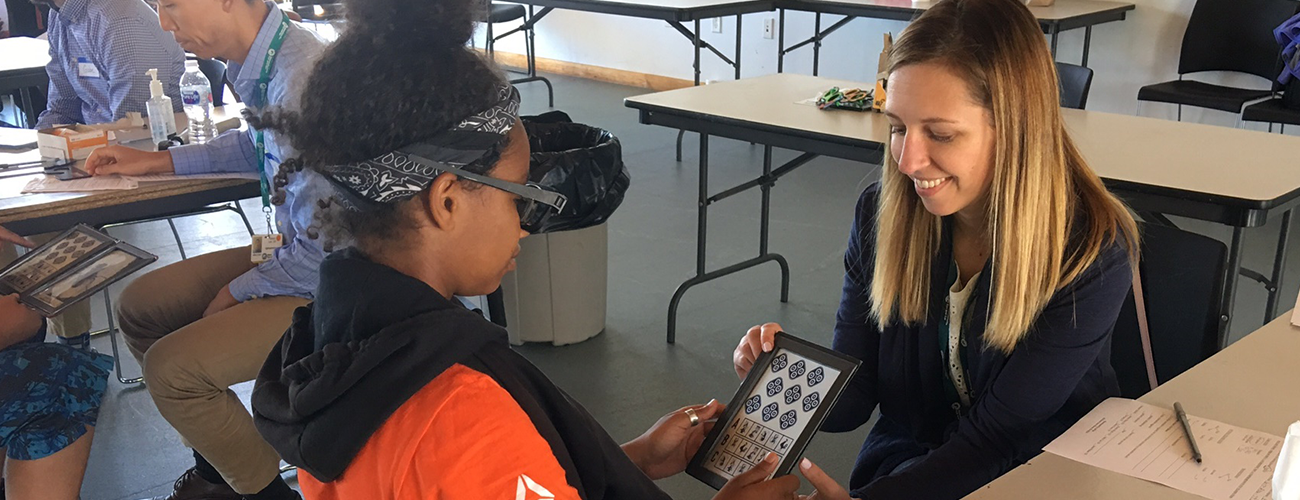 optometrist performs an eye exam during a community outreach visit