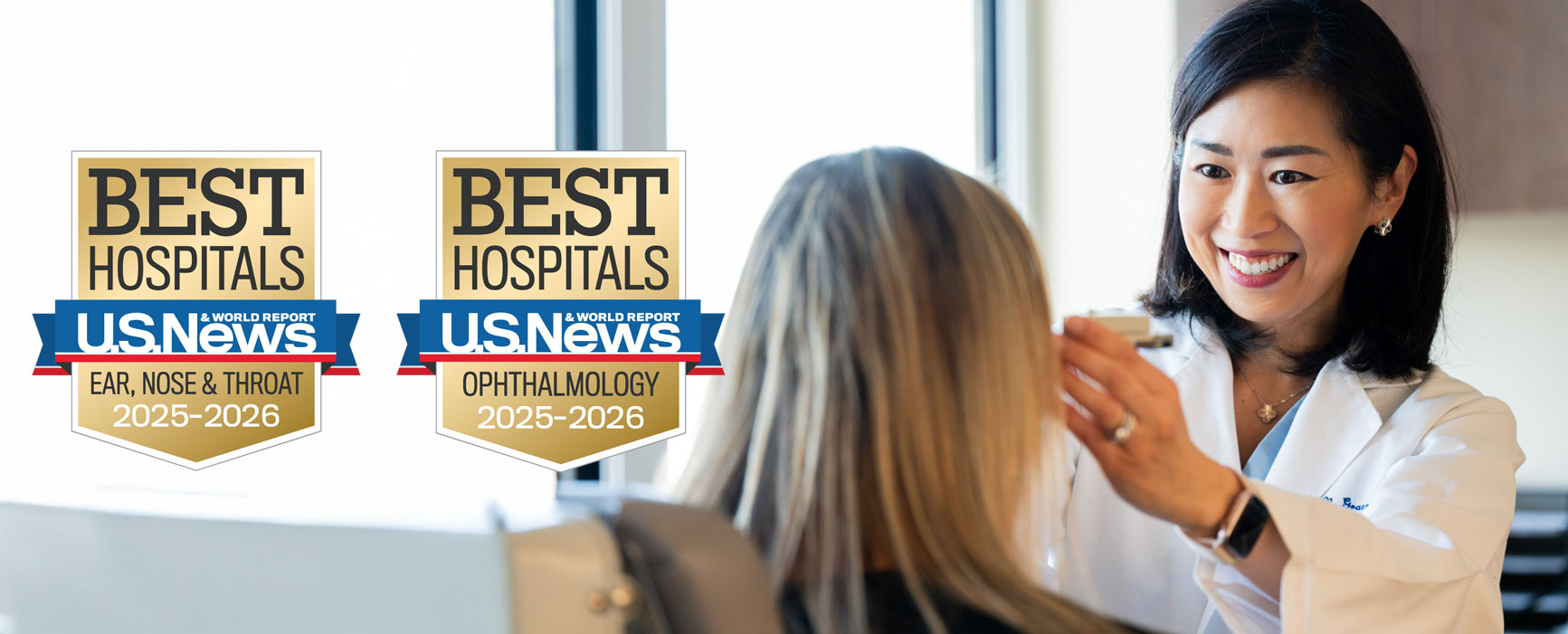 female provider performing an eye exam on patient with US News & World Report badges at left