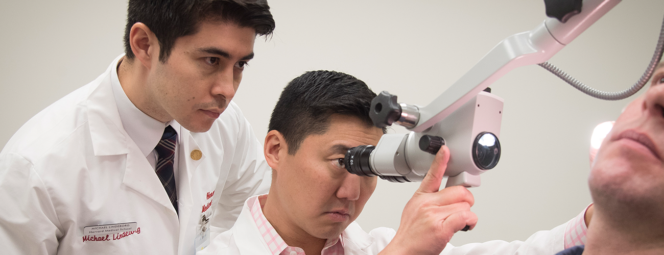 medical trainee with ear doctor examining patient