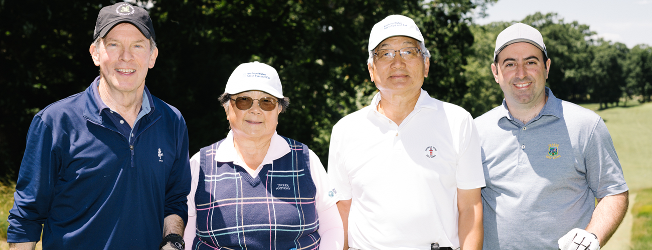 four attendees at mass eye and ear golf tournament