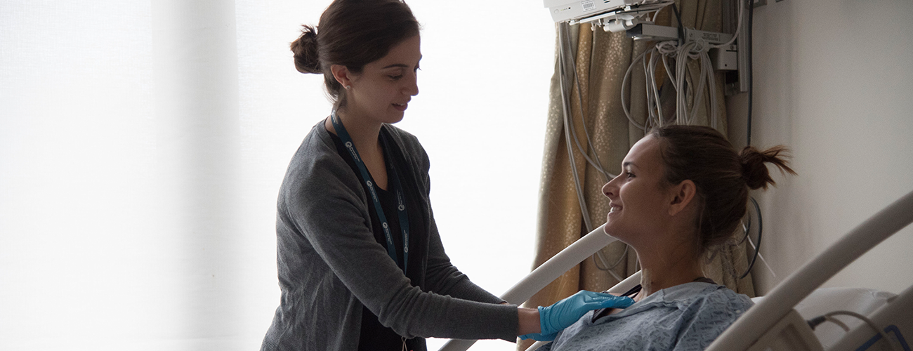 nurse caring for patient in room