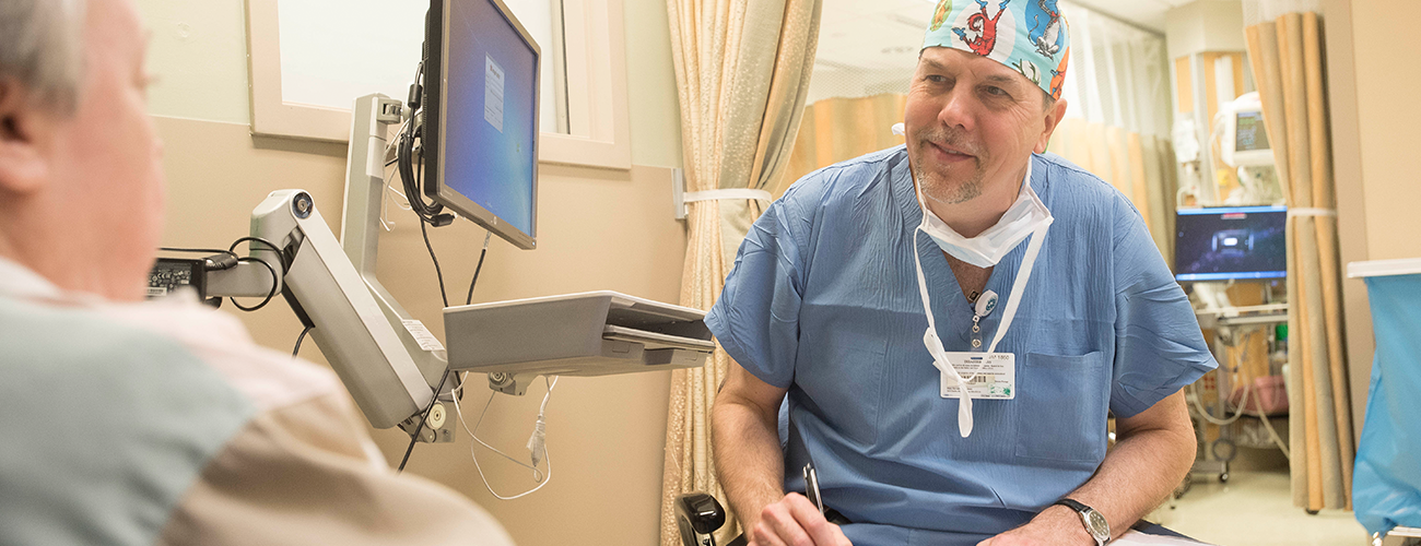 anesthesiologist consulting with a patient in an exam room