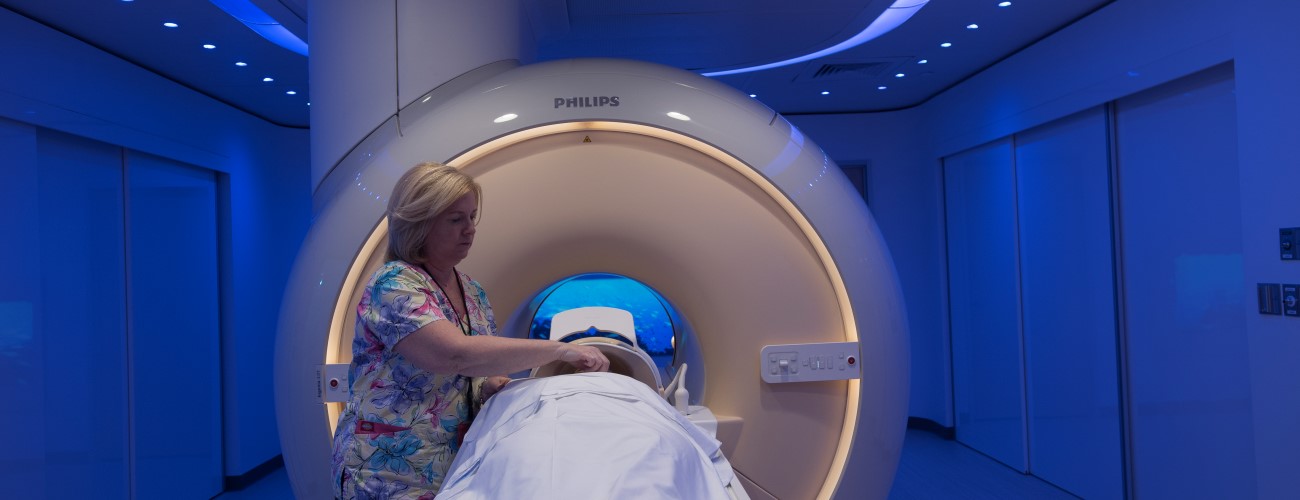 radiology technician sets up an MRI for a patient