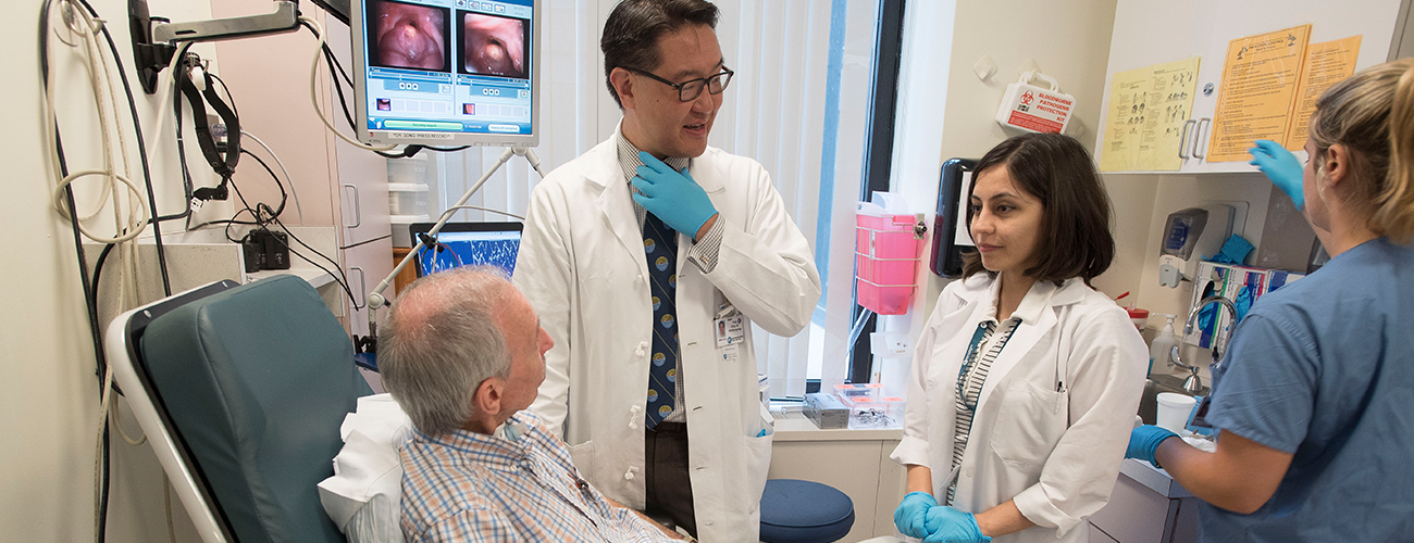 laryngology fellow with throat doctor speaking to patient